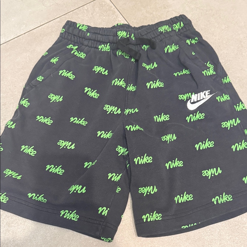 Nike Men's Black Shorts with Green Logo Pattern